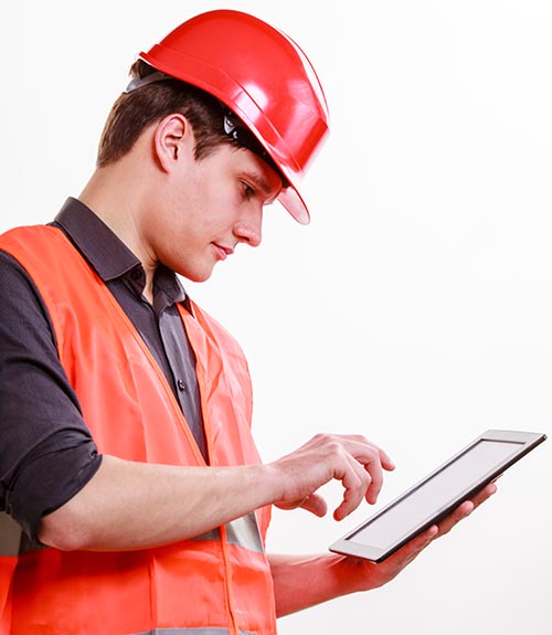 HVAC contractor using a tablet to enter labor data into construction time tracking software.