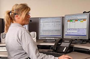 Service dispatcher using SAMPro field service software for contractors.