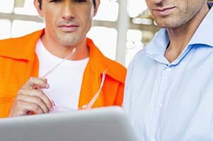Two contractors using field service software to create a customer quote.